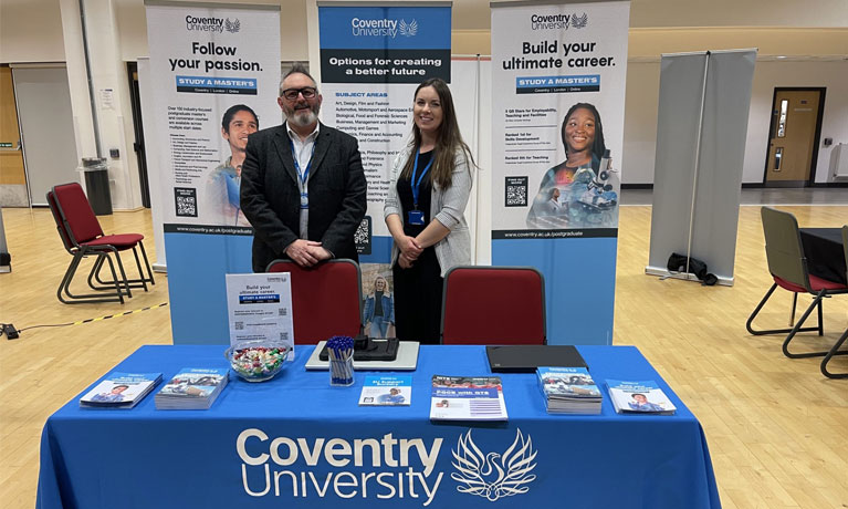 Coventry University staff at a postgraduate event desk