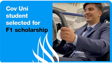 Student sitting in a f1 car simulator