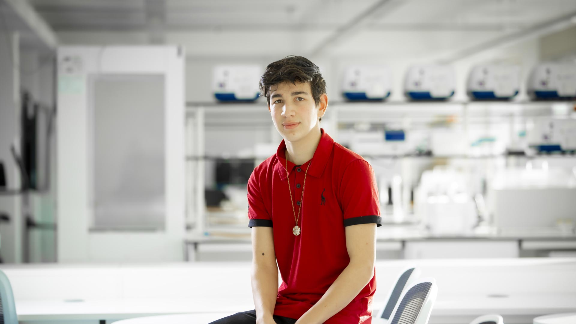 Electro-Mechanical Engineering student sat in a lab.