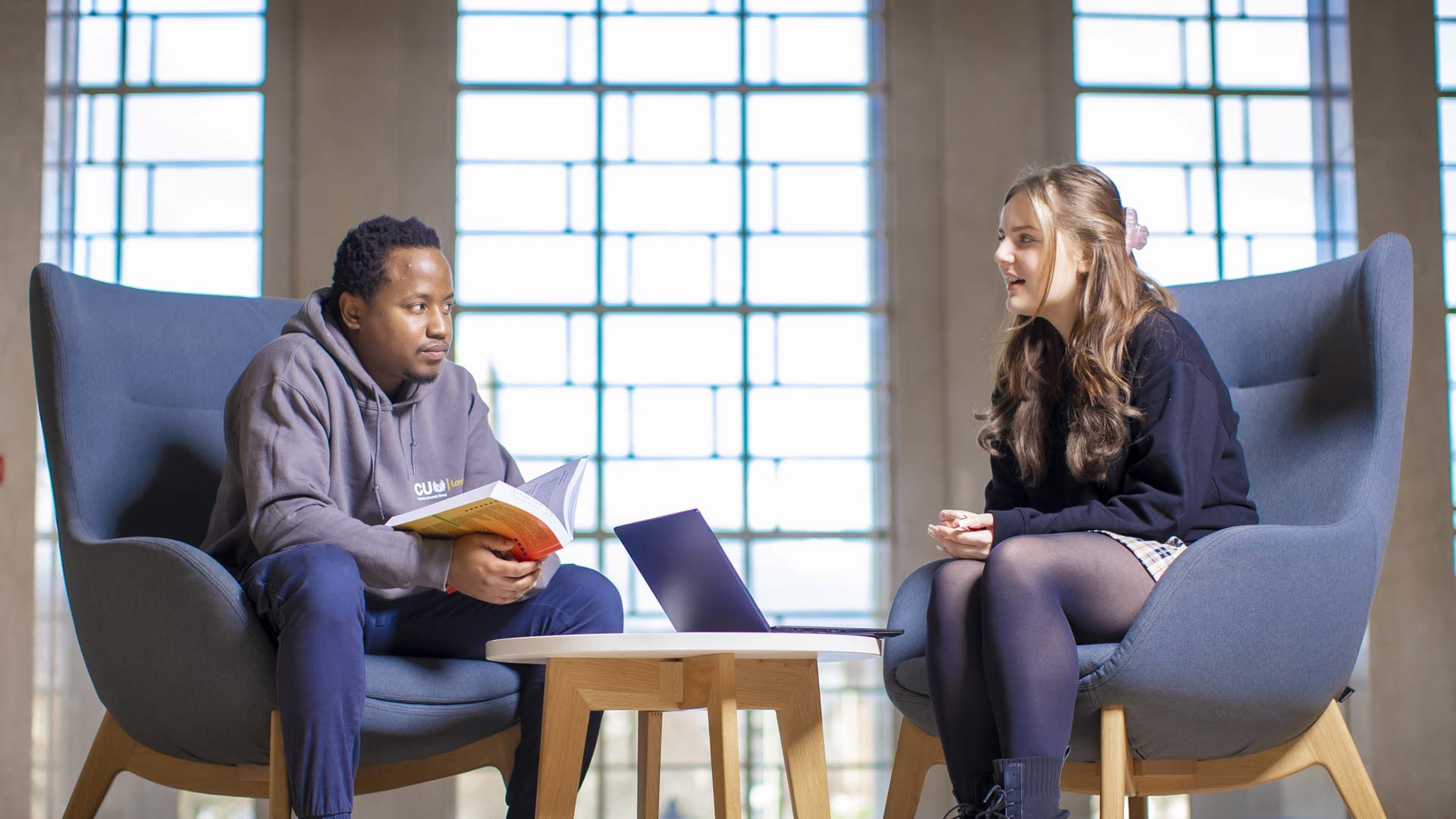 Two Applied Psychology students roleplaying as therapist and patient.