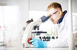 Student using a microscope in a laboratory.