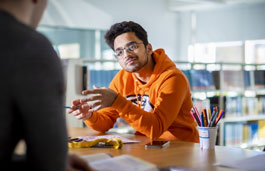 Students talking in a library.