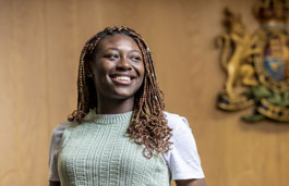 A student smiling in the moot courtroom.