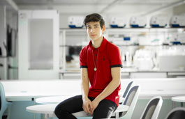 Electro-Mechanical Engineering student sat in a lab.