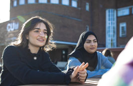 A group of students sat outside the CU London Dagenham building.
