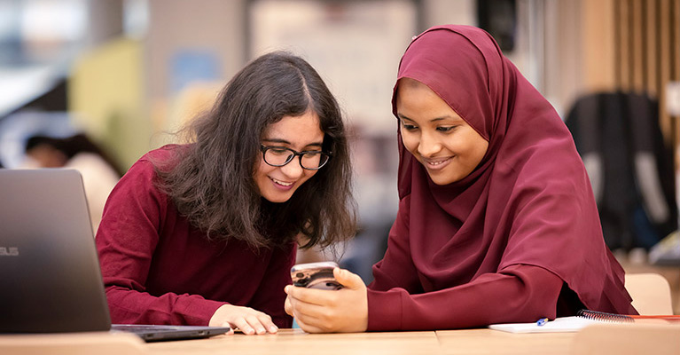 Two ladies looking at a phone