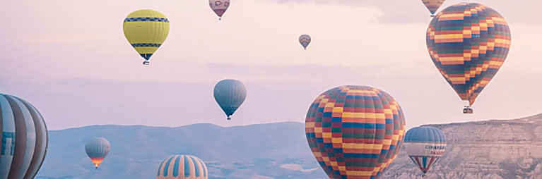 Hot air balloons over mountains