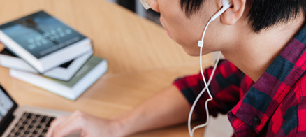 Person on laptop wearing headphones