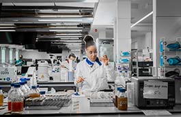 Medical students in a lab looking at a test tube