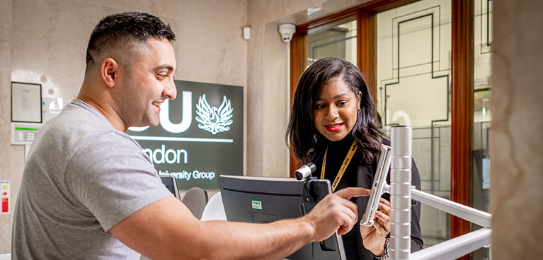 Student being helped by a member of staff inside the Dagenham building