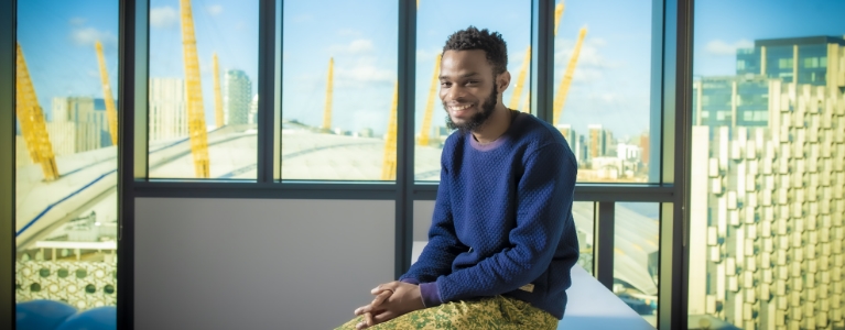 Man sitting in a room with the O2 in the background