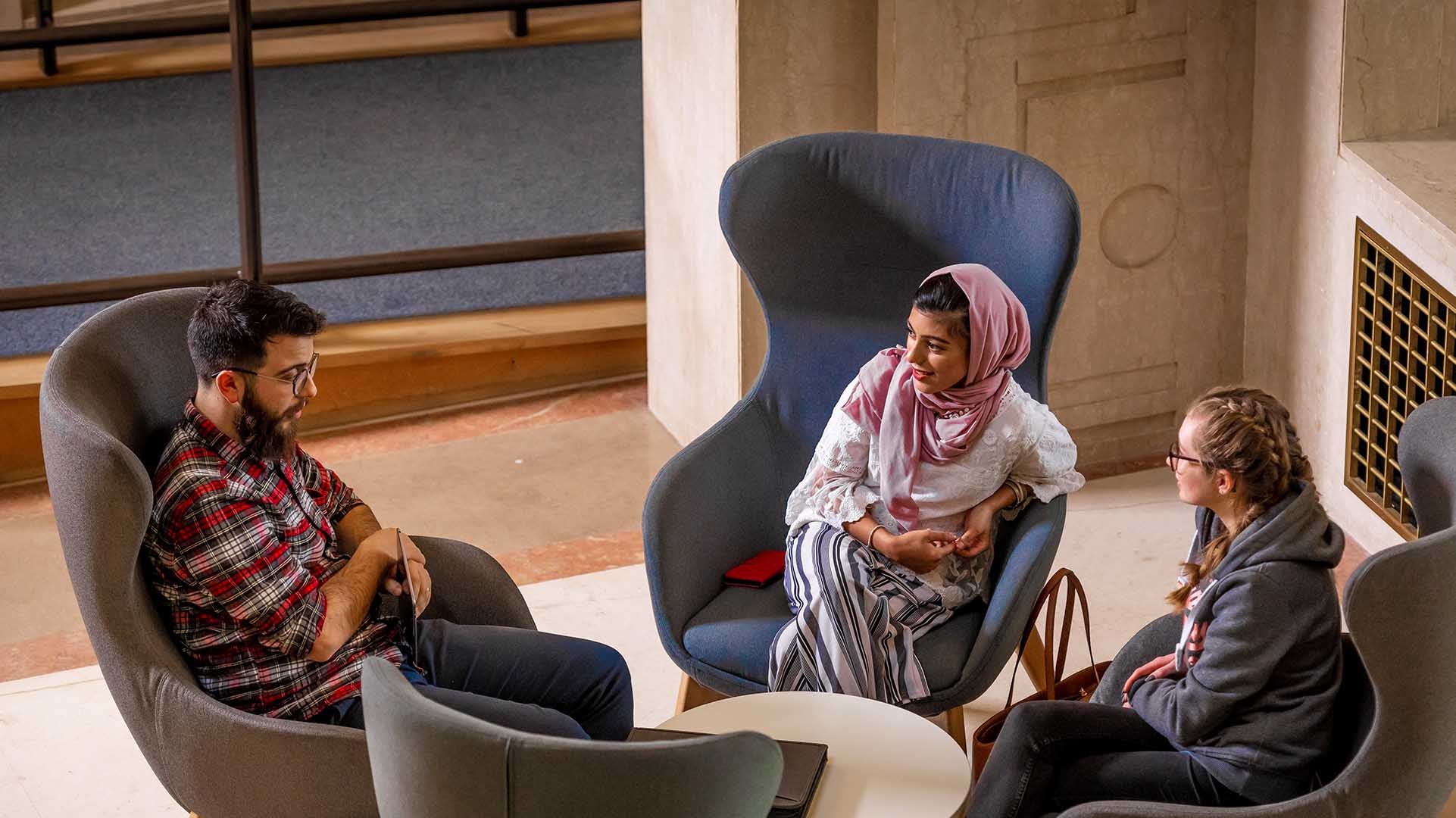 Three Primary Education & Teaching Studies students sitting in discussion