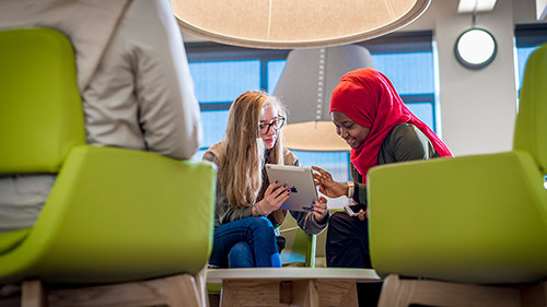 Two students sat down with a tablet