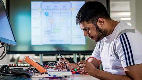 Engineering student wiring their project