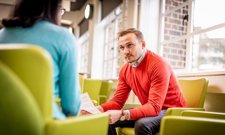 Two students sat inside talking