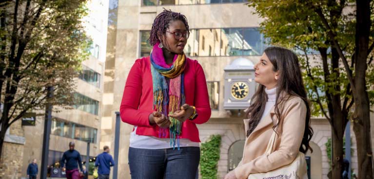 Two women outside talking