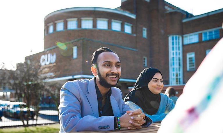 Group of students sat outside of the CU London building