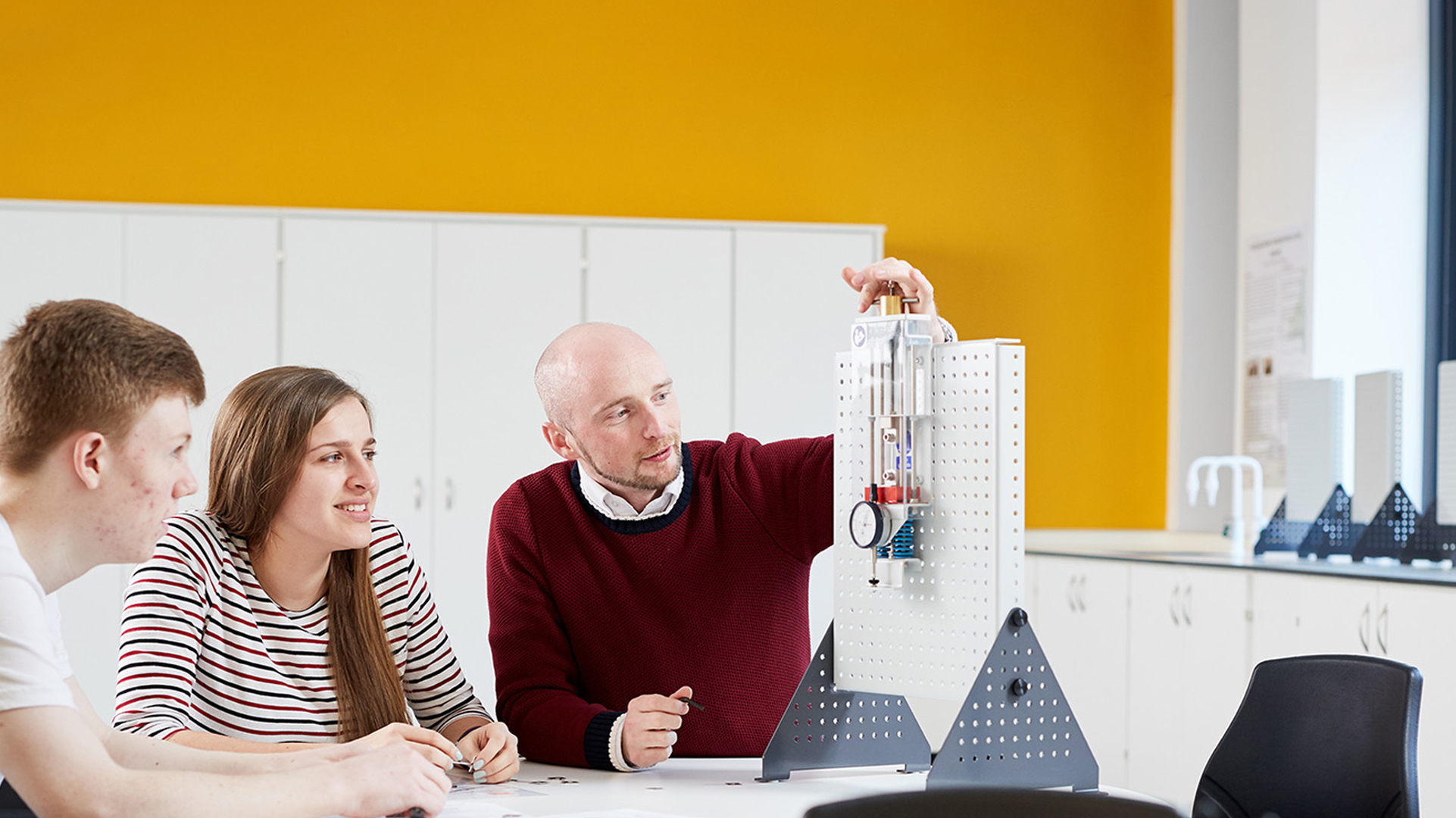 Three Electro-Mechanical Engineering students using equipment