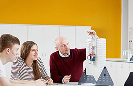 Three Electro-Mechanical Engineering students using equipment