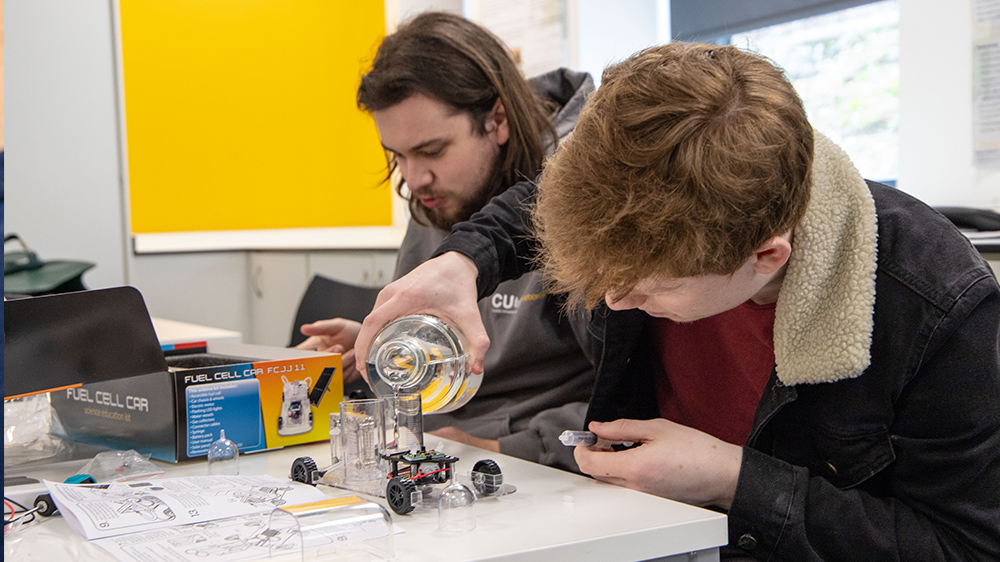 Two Electro-Mechanical Engineering students creating a prototype