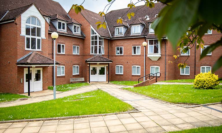 Exterior view of Cayley Halls with greenery