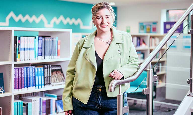 Student standing in the library