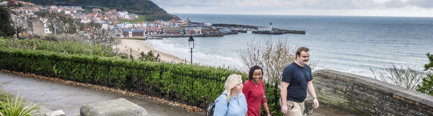 Students walking in front of Yorkshire seaside