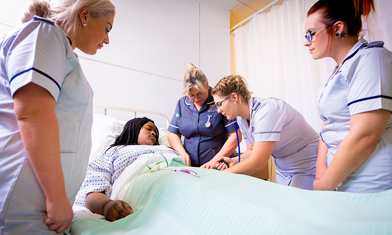 Student nurse taking a patients blood pressure