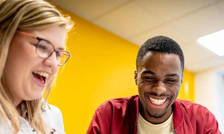 Two students laughing