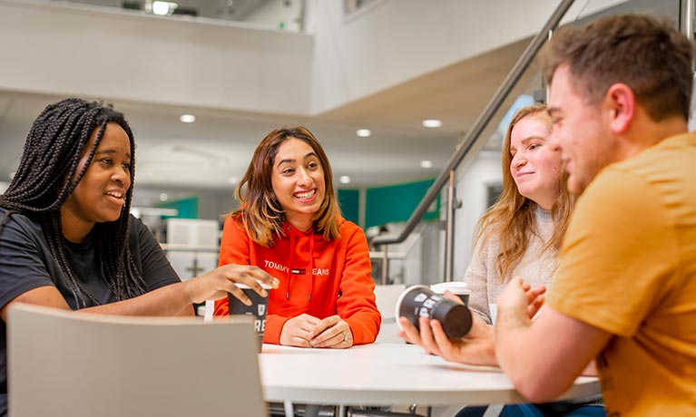 A group of people sitting around a table talking