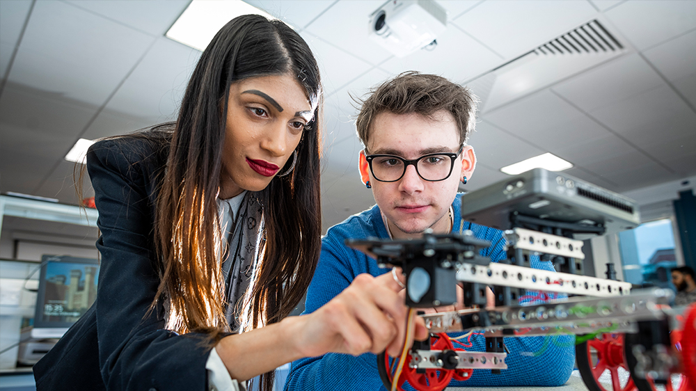 Two students working on a robot