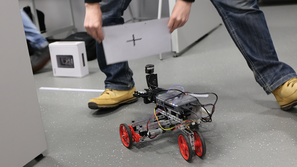 Engineering student testing a robot