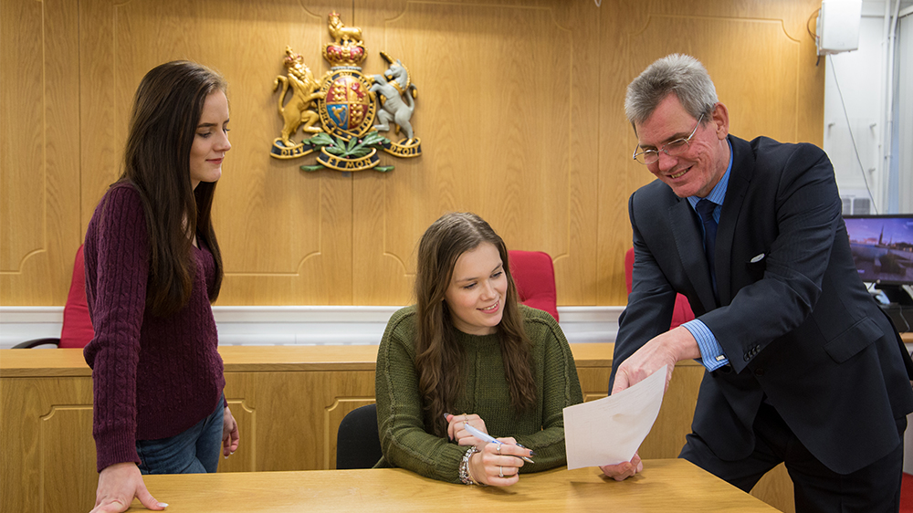 Students with a tutor in the moot courtroom