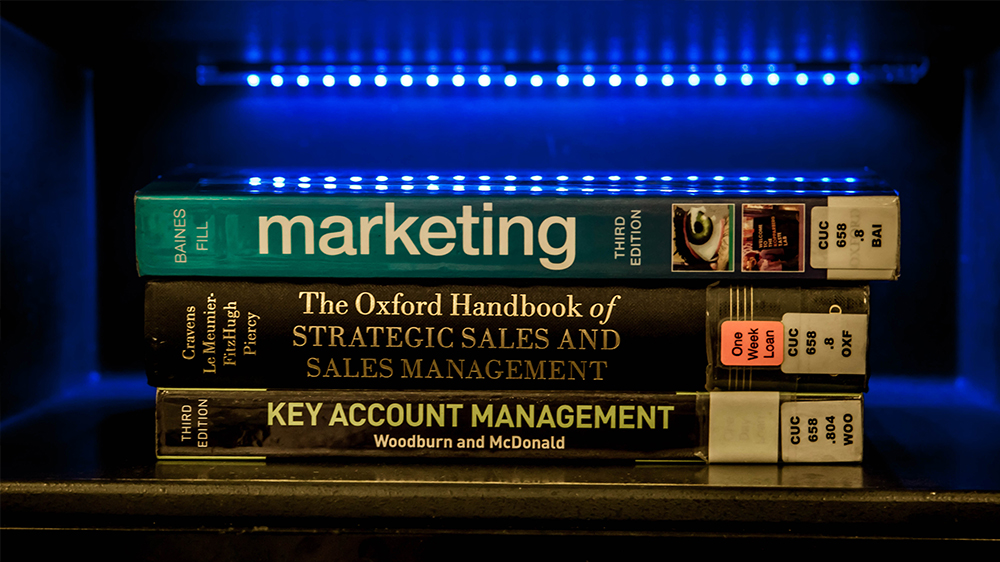 Marketing textbooks stacked in a pile