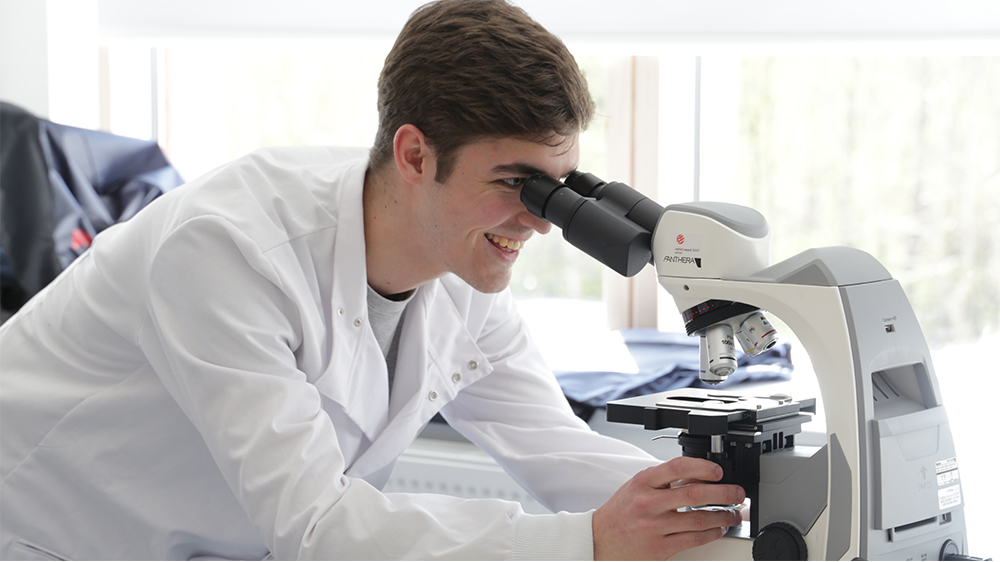 Student using a microscope in the lab