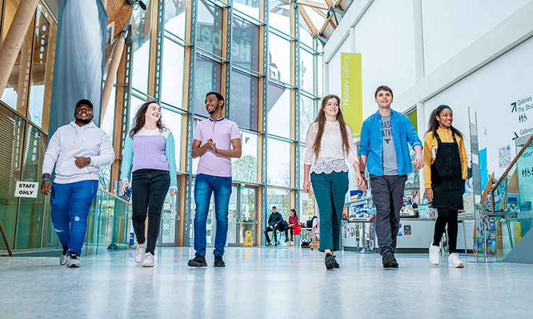 group of young students walking together in the Herbert museum