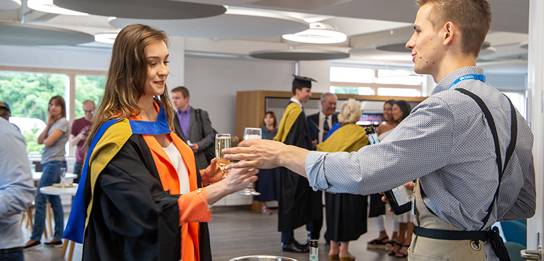 Student celebrating at the Mile Lane campus after the ceremony