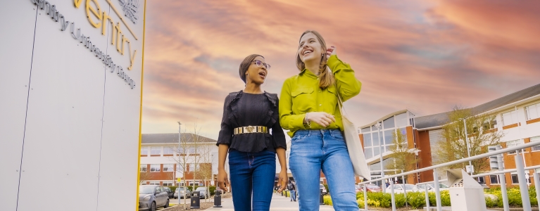 Two women walking outside CU Coventry grounds