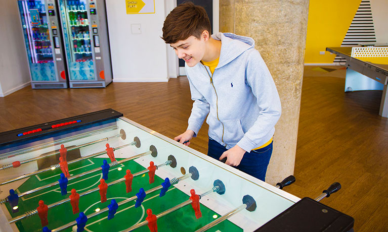 Student playing table football