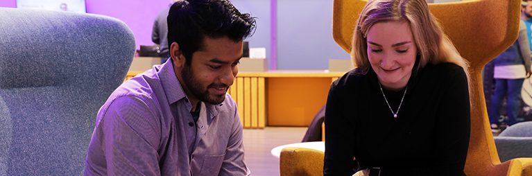 two students sitting together in the student hub