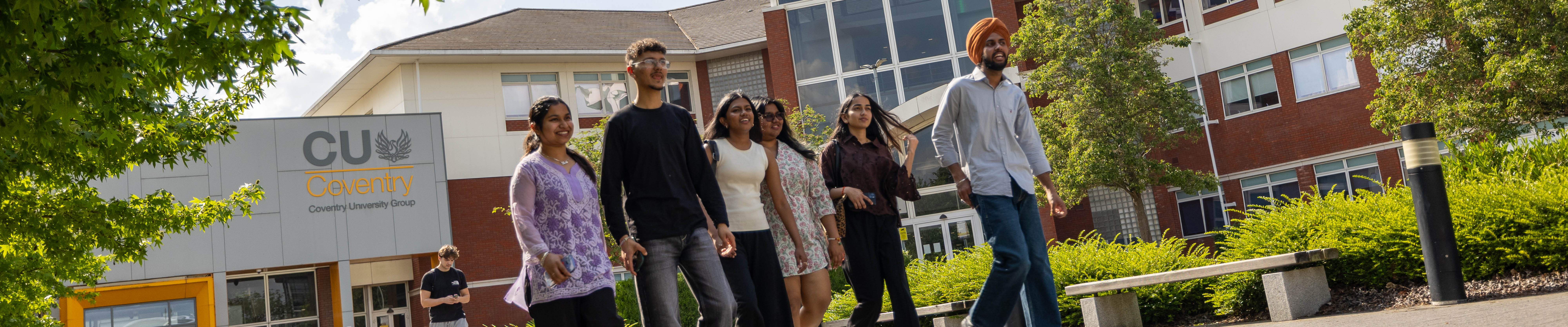 Large group of students walking away from Mile Lane on a summers day