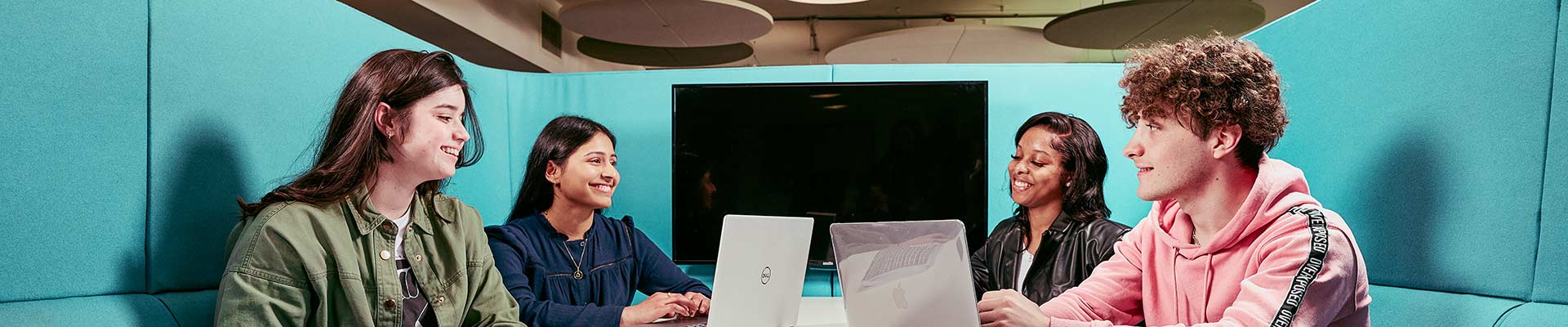 Students sitting together in a study booth