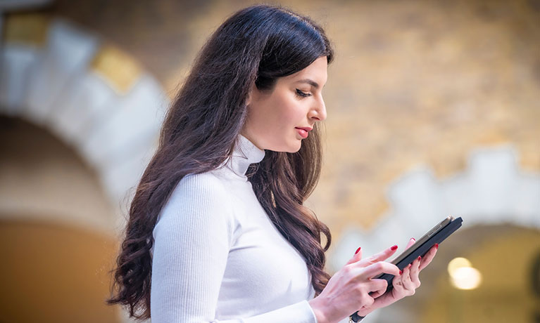 Women looking at her phone outside of a building