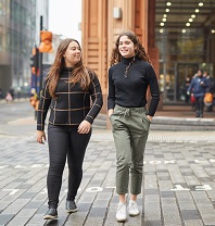 Two women walking down a street