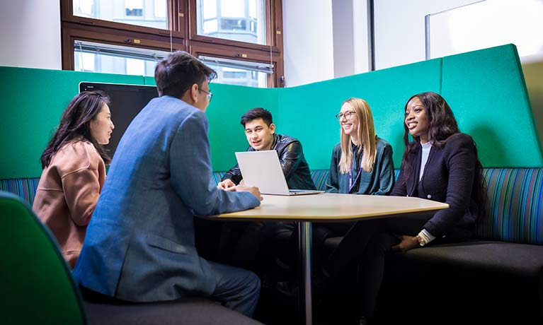 Group of students sitting in a booth 