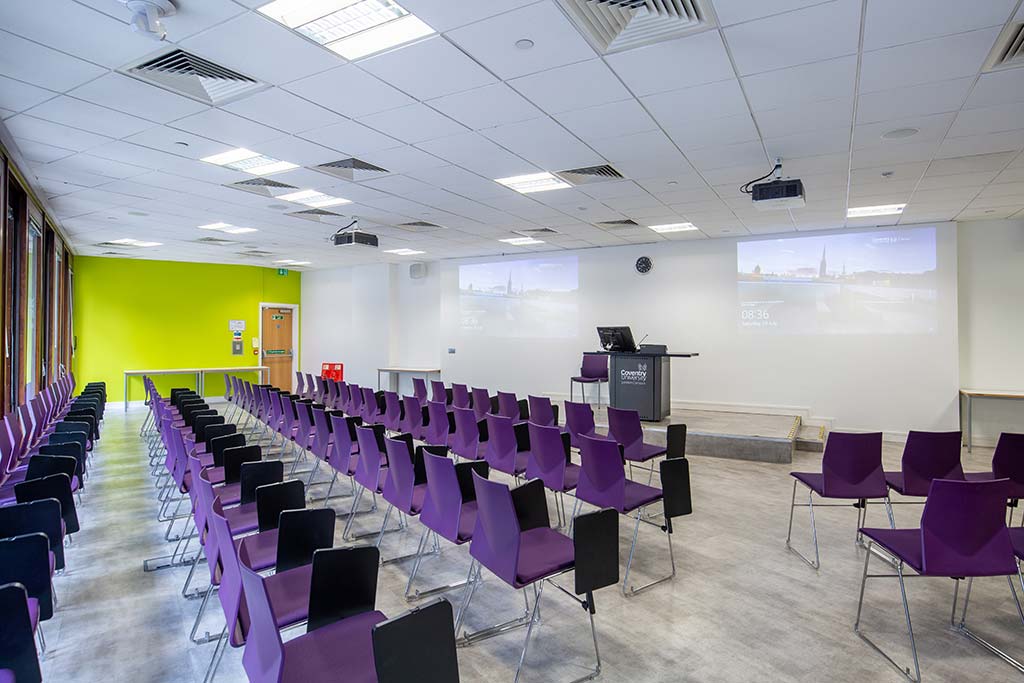 Rows of purple chairs in a lecture theatre
