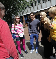 Group of people stood outside smiling on a sunny day