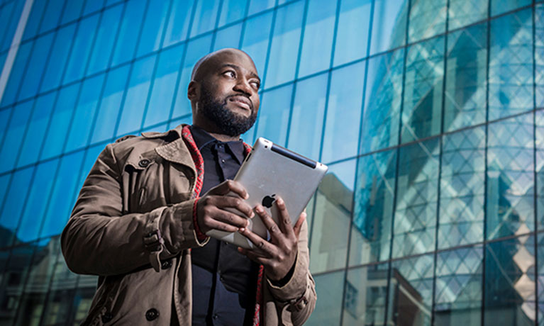 Tall man holding a tablet