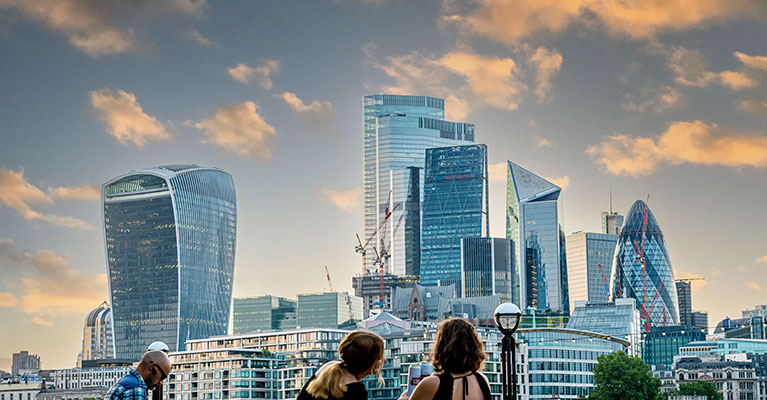 Three people looking over towards the London skyline