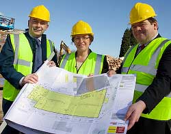 Workers on constuction site wearing ]high vis jackets and helmets